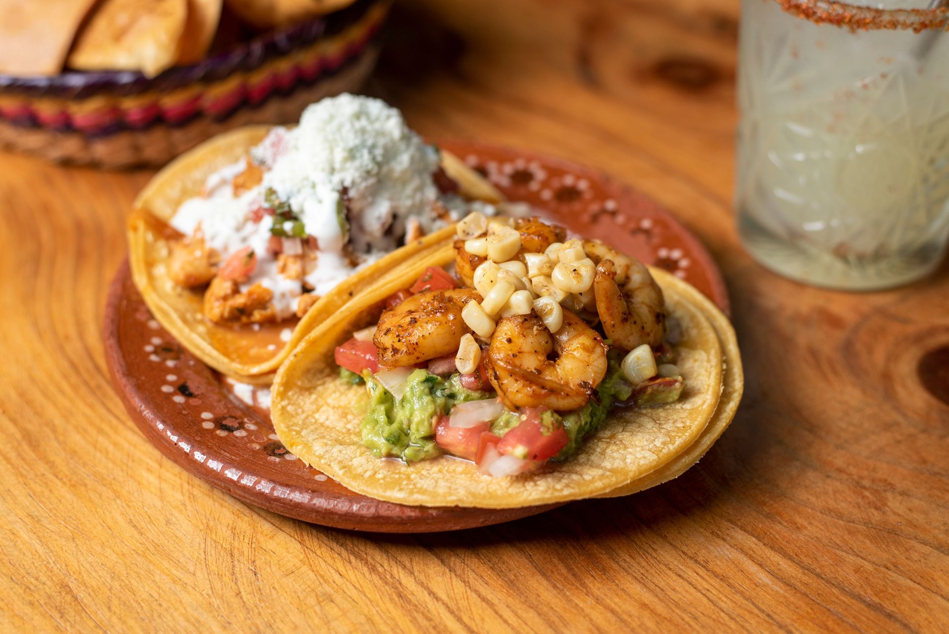 Delicious shrimp tacos with fresh ingredients, served on a traditional Mexican plate.
